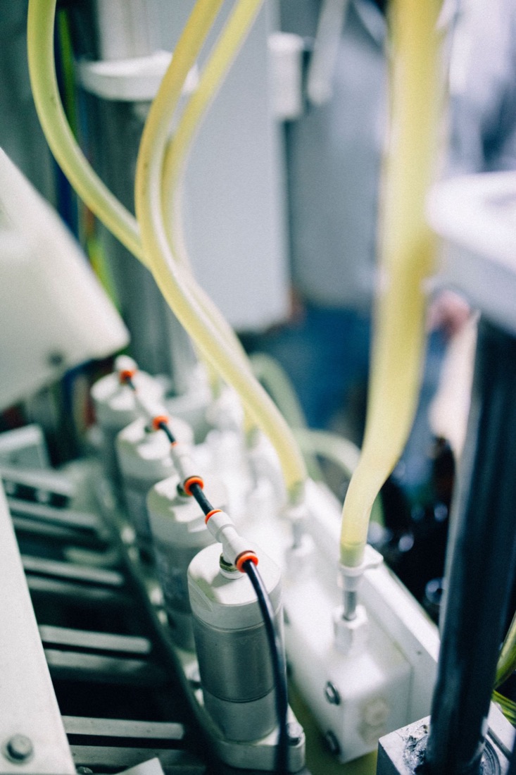 Close-up of tubing and fittings on a production line