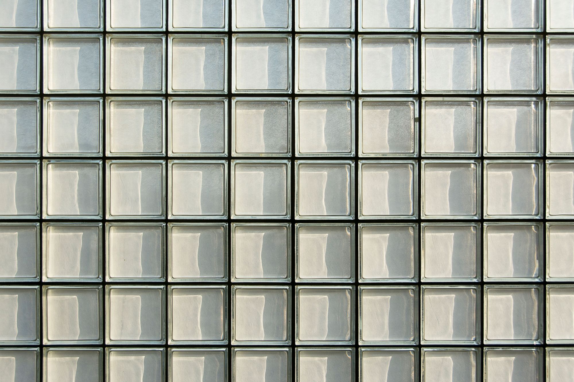 A wall of glass blocks lit softly from behind